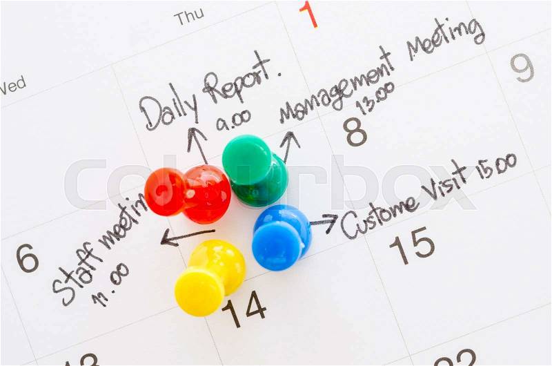 Pushpin on calendar with busy day overworked schedule, stock photo