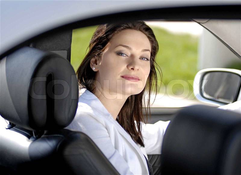 Beautiful businesswoman siting in the premium car, stock photo