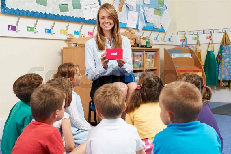 Teaching Showing Flash Cards To Elementary School Class, stock photo