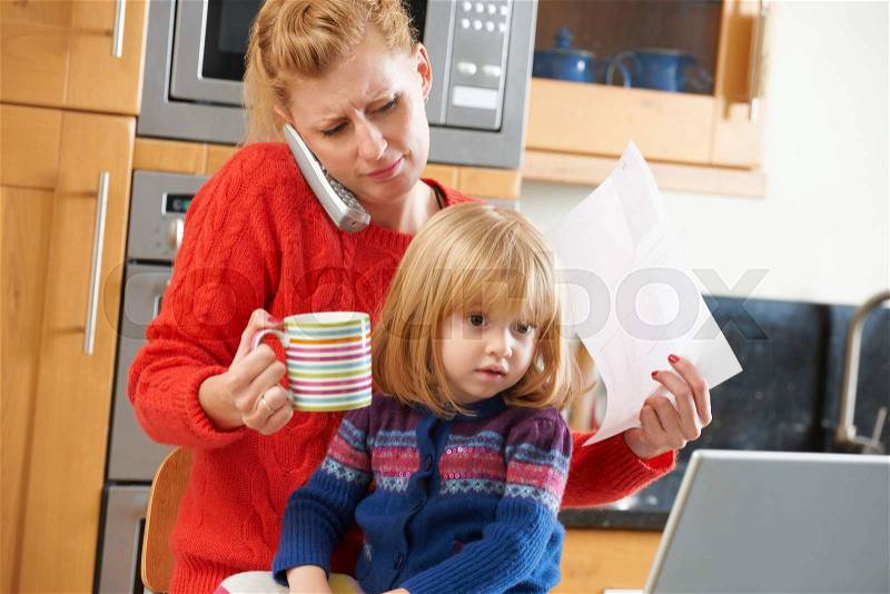 Busy Mother Coping With Stressful Day At Home, stock photo