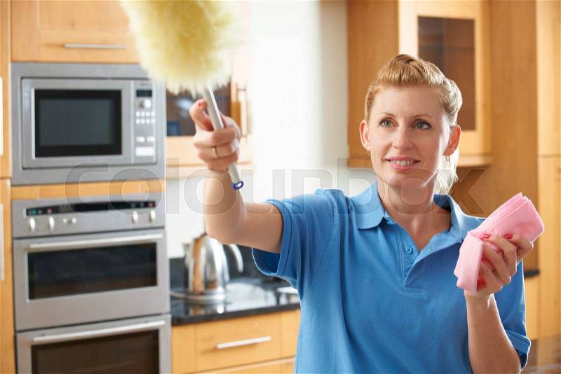 Female Cleaner Working In Kitchen, stock photo