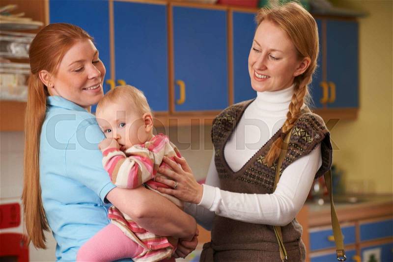 Working Mother Dropping Baby At Nursery, stock photo