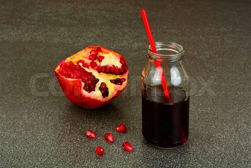 Pomegranate Juice and Pomegranate Cut. Studio Photo, stock photo