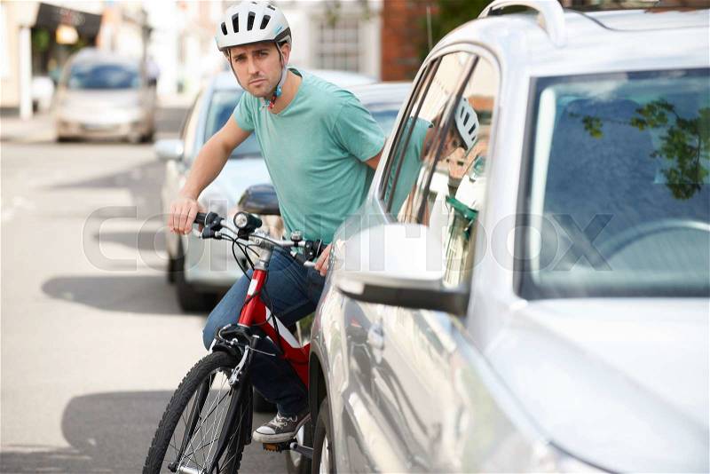 Young Man Cycling On Urban Street, stock photo