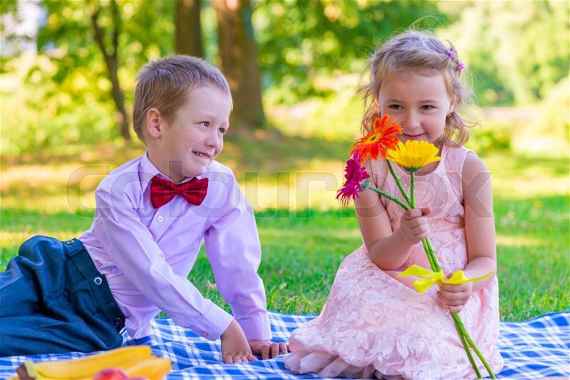 6year old children on a date in the summer park, stock photo