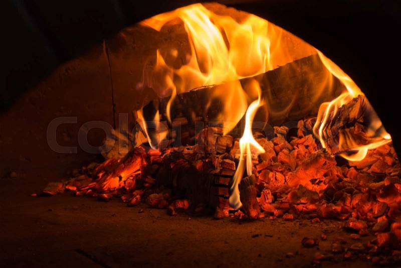 Fire in the oven. Traditional Pizza oven, stock photo
