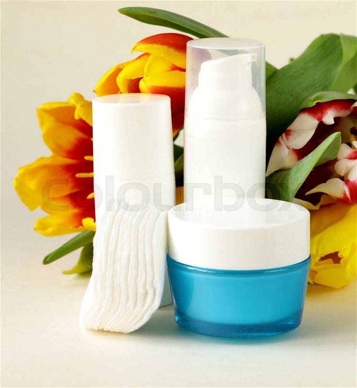 Assortment of jars creams lotion with flowers - organic cosmetics, stock photo