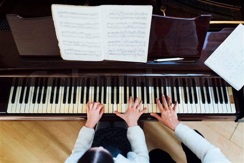Piano lessons at a music school, teacher and student. top view, stock photo