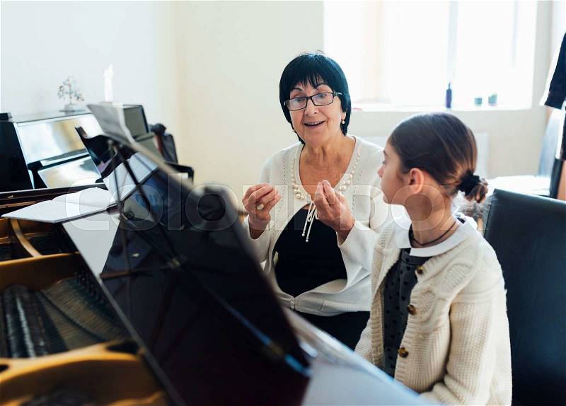 Master piano student explains the important things, stock photo