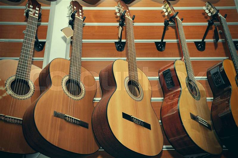 Row of classical acoustic guitars in musical store, stock photo