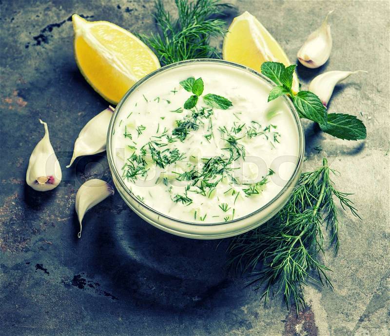 Tzatziki sauce. Fresh dip with herbs dill and mint. Vintage style toned, stock photo