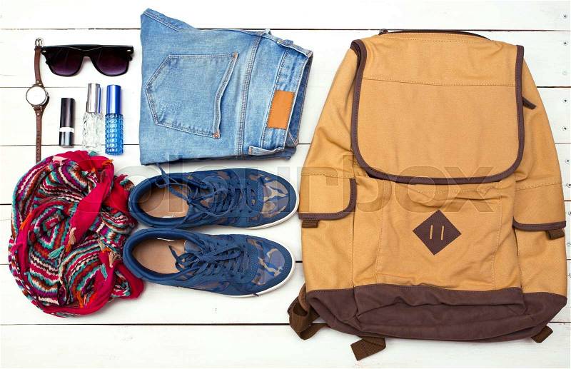 What to Pack in Your Carry On girl Bag - backpack, money, glasses, shoes, jeans, accessories , stock photo