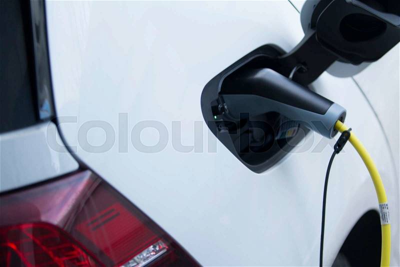 Charging an electrical car, stock photo