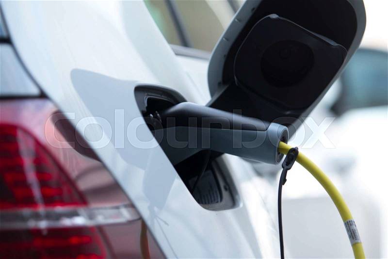 Charging an electrical car, stock photo