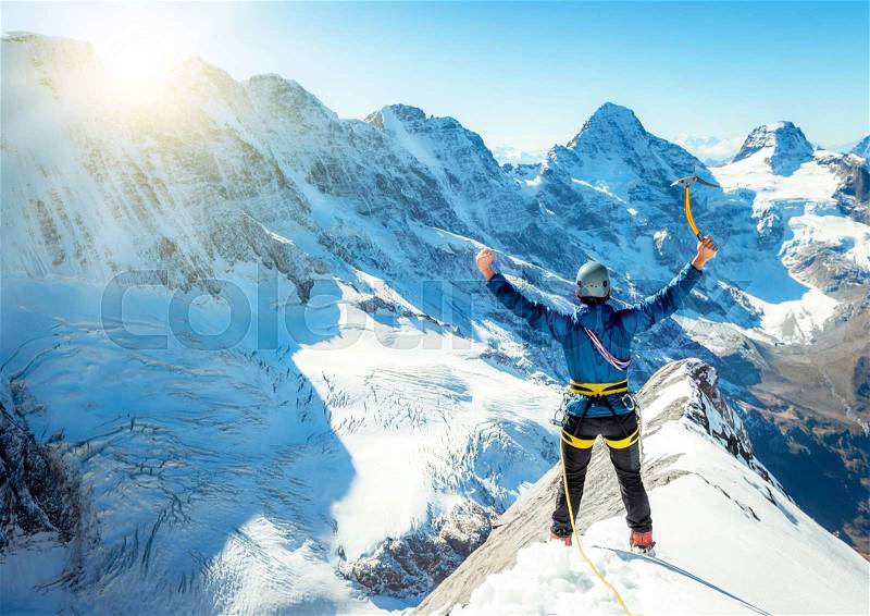 Climber reaching the summit. Extreme sport concept, stock photo