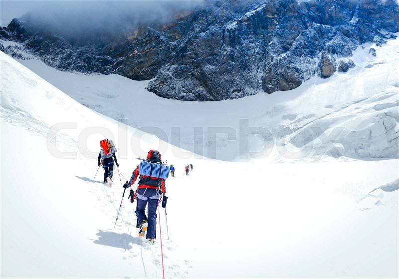 Group of climbers reaching the summit. Extreme sport concept, stock photo