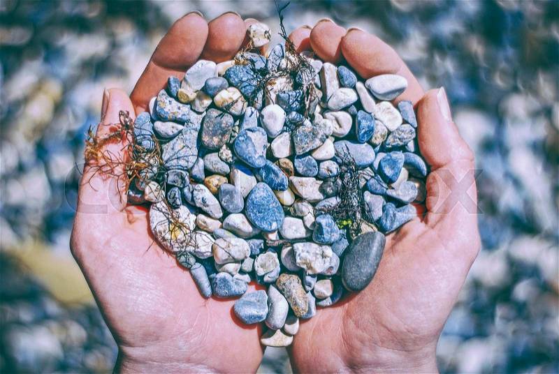 Handful of stones in hands. Natural concept, stock photo