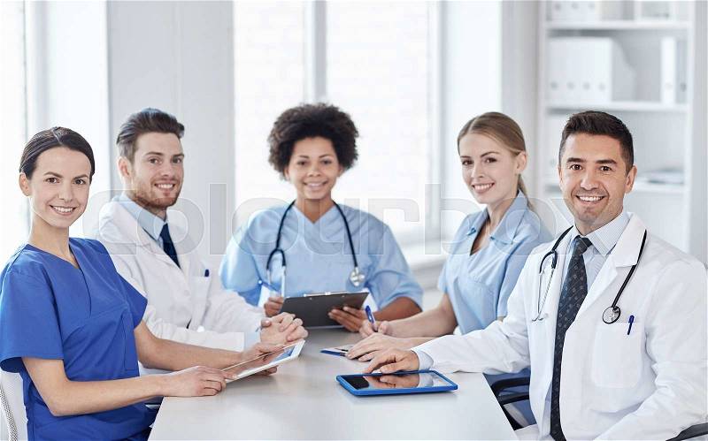 Hospital, profession, people and medicine concept - group of happy doctors meeting at medical office, stock photo