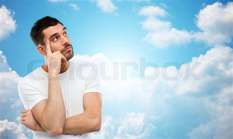 Doubt, expression and people concept - man thinking over blue sky and clouds background, stock photo