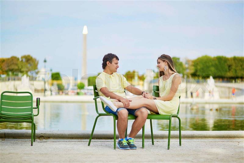 Beautiful young dating couple in Paris in the Tuileries garden, stock photo