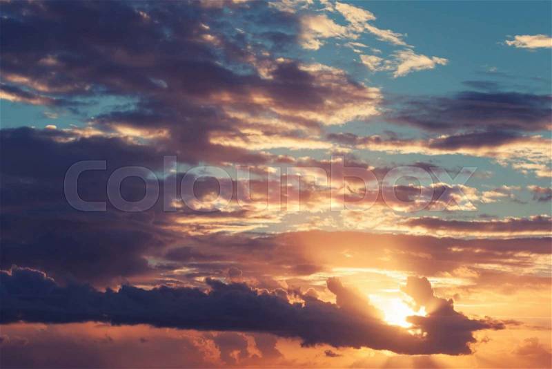 Colorful sunrise sky with red clouds and shining sun, tonal correction photo filter effect, stock photo