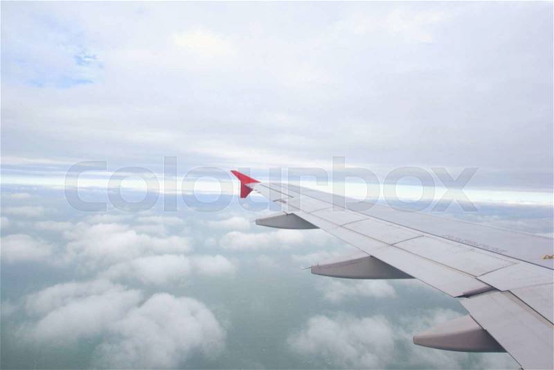 Plane wing, white clouds and blue sky, stock photo