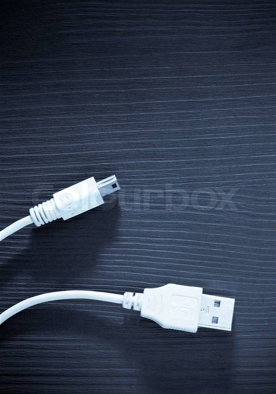 Usb cable on wooden table, stock photo
