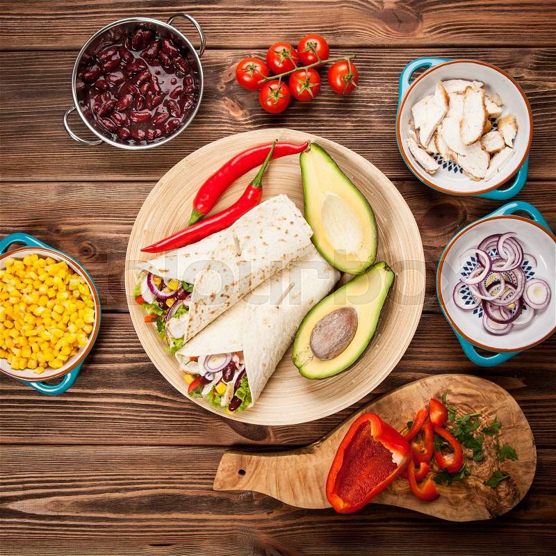 Traditional mexican tortilla wrap with a mix of ingredients, stock photo