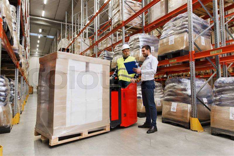 Wholesale, logistic, people and export concept - manual worker on forklift loader and businessmen with clipboard at warehouse, stock photo