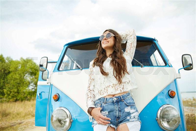 Summer holidays, road trip, vacation, travel and people concept - smiling young hippie women in minivan car, stock photo