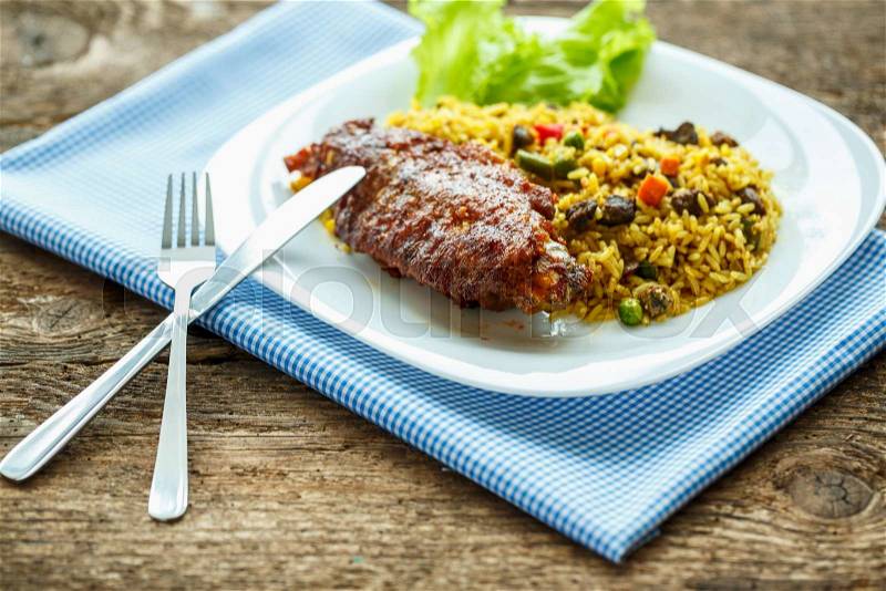 Delicious dish of turkey meat with rice and lettuce, stock photo