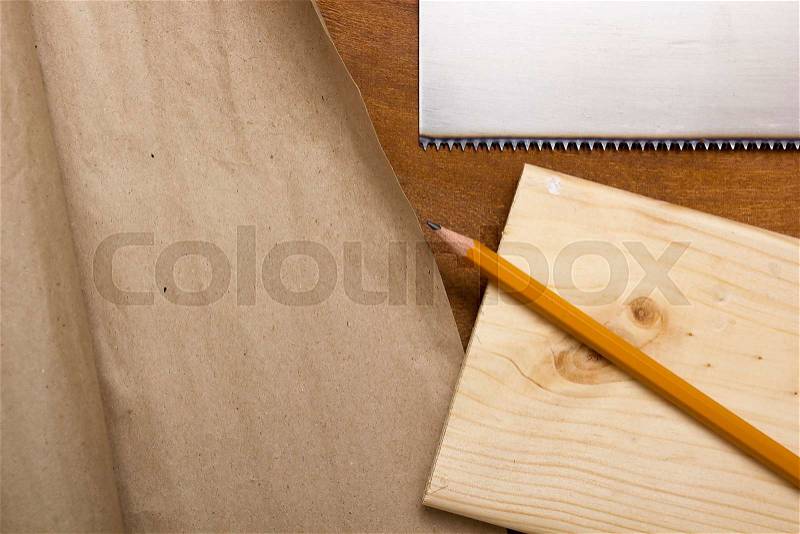 Board, pencil and paper packaging on the wooden table, stock photo
