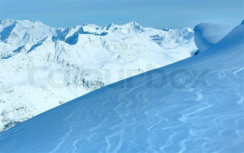 Winter mountain scenery from hill and shining snow on slope in front (Tyrol, Austria), stock photo