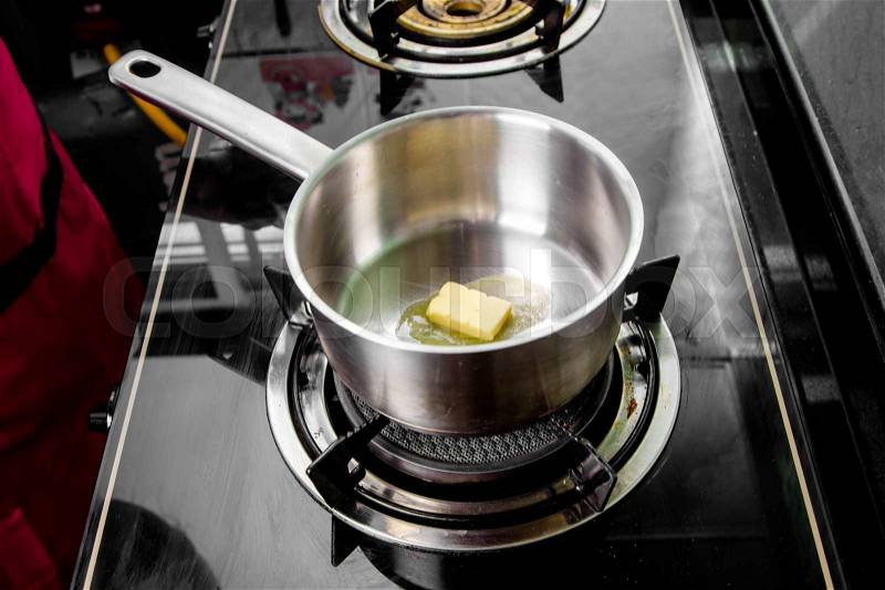 Chef making melt butter in pot, stock photo