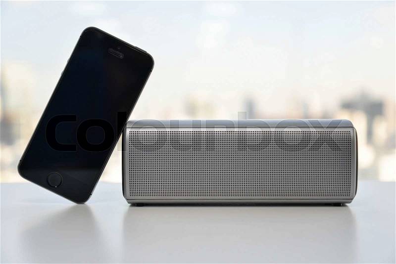 Wireless Speaker connected to Mobile phone, stock photo