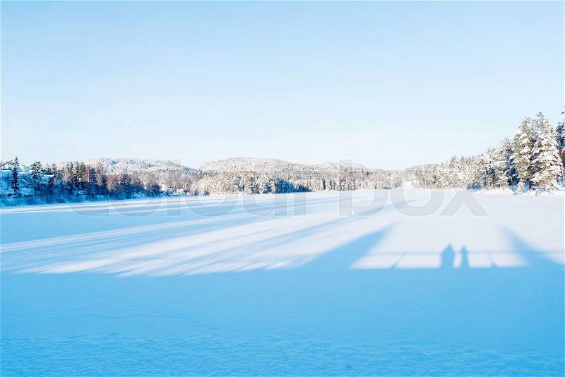 Frozen lake in winter at sunset, stock photo