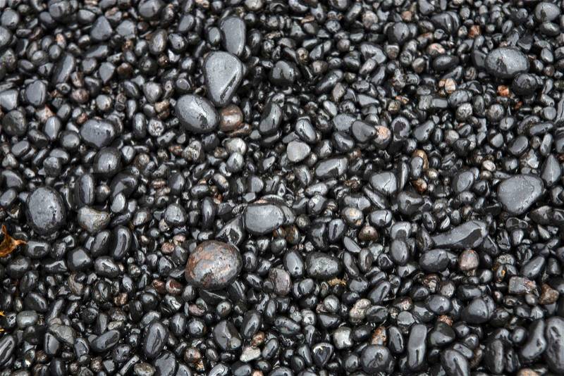 Wet sea pebbles on a beach close up, stock photo