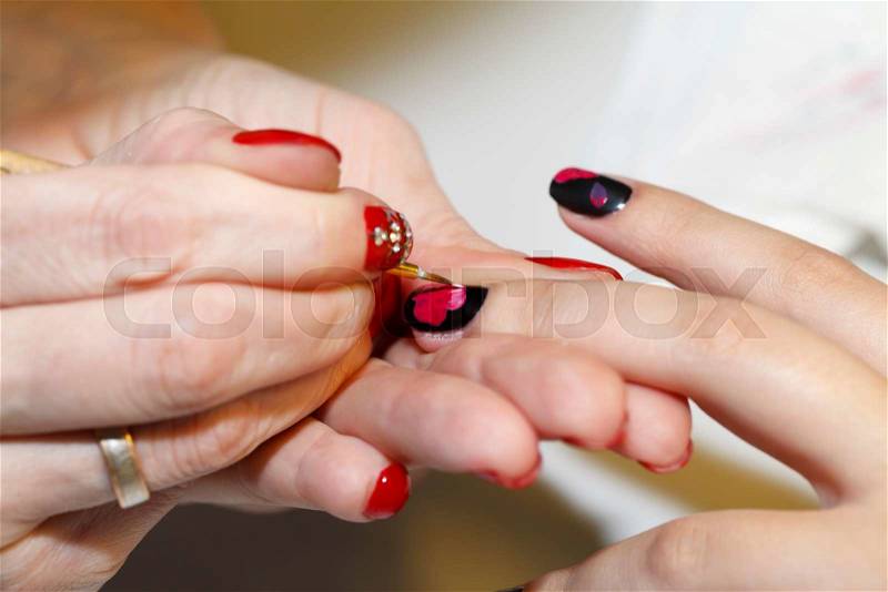 Manicurist makes the new gel polish manicure, close-up, beauty and body care, stock photo