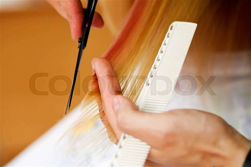 Stylist hairdresser doing haircut closeup of work equipment, the beauty industry, stock photo