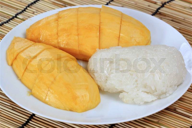 Ripe mango and sticky rice cooked with coconut milk ,Thai dessert , stock photo