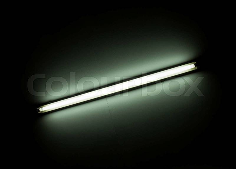 Detail of a fluorescent light tube mounted on a wall, stock photo
