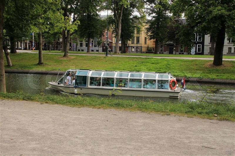 The launch is floating in one of the canals in the city Utrecht in the summer, stock photo
