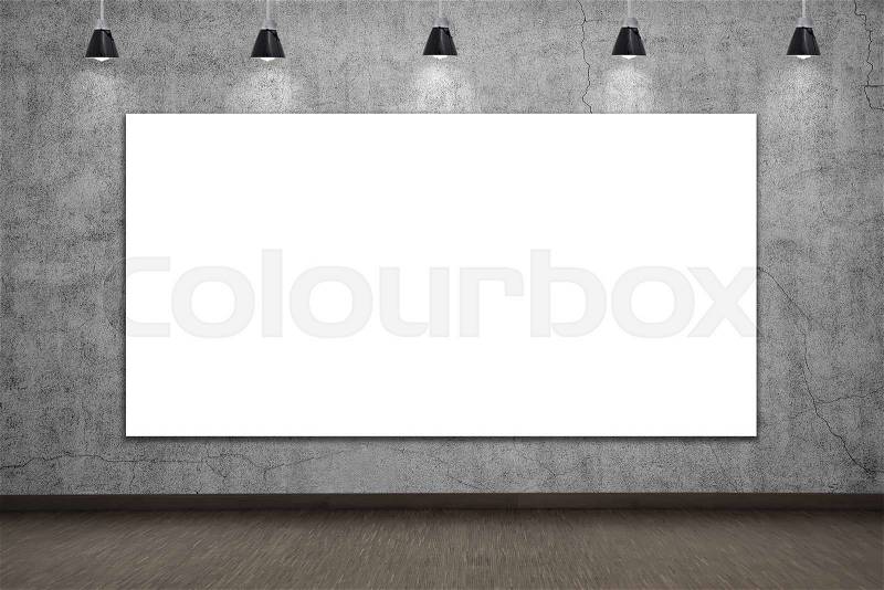 Blank placard on concrete wall in loft room, stock photo
