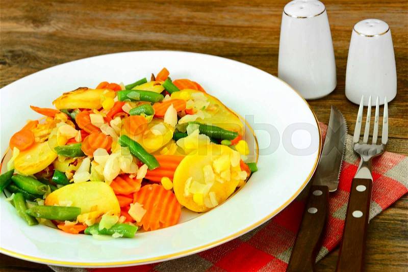 Steamed vegetables potatoes, carrots, corn, green beans and onion Studio Photo, stock photo