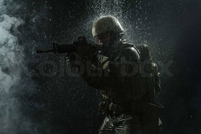 Green Berets US Army Special Forces Group soldier in the rain, stock photo