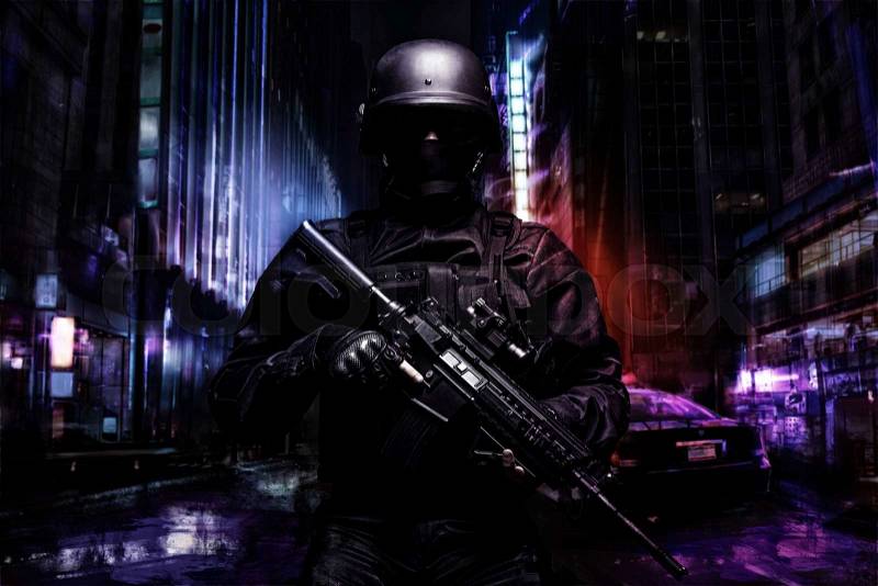 Spec ops police officer SWAT in black uniform on the street, stock photo