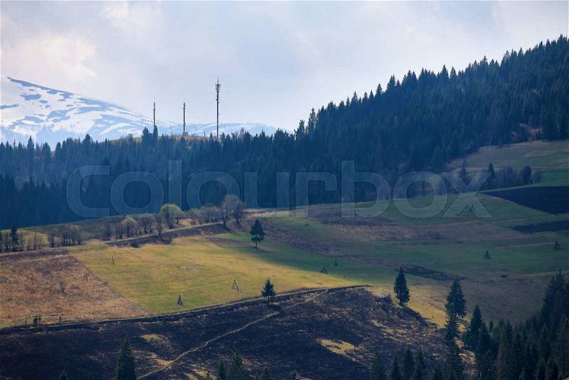 Sunny spring in mountain village. Fields and hills. April in Ukraine Carpathians, stock photo