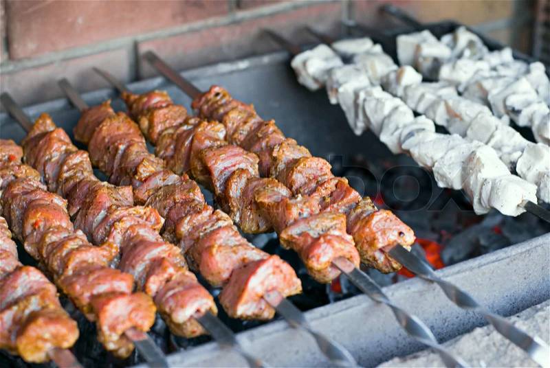Raw kebab, meat and fish on a grill, barbecue, stock photo