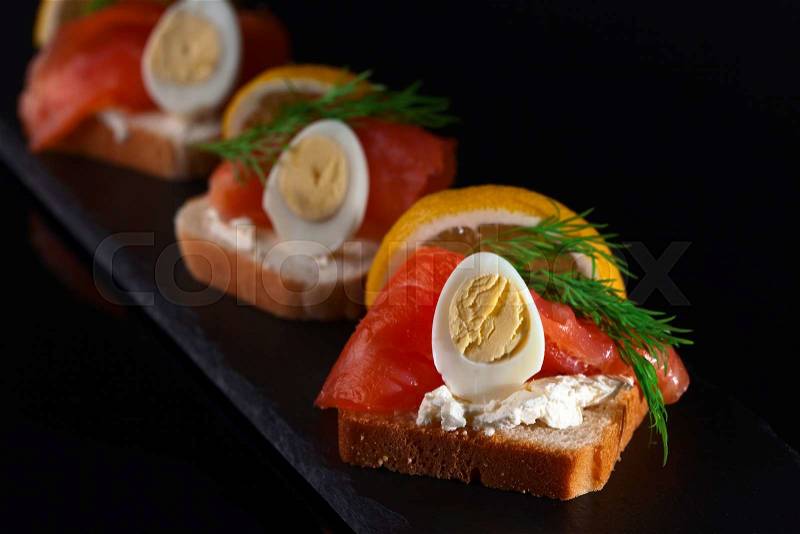 Sandwich with salmon , egg and dill , focus on foreground, stock photo