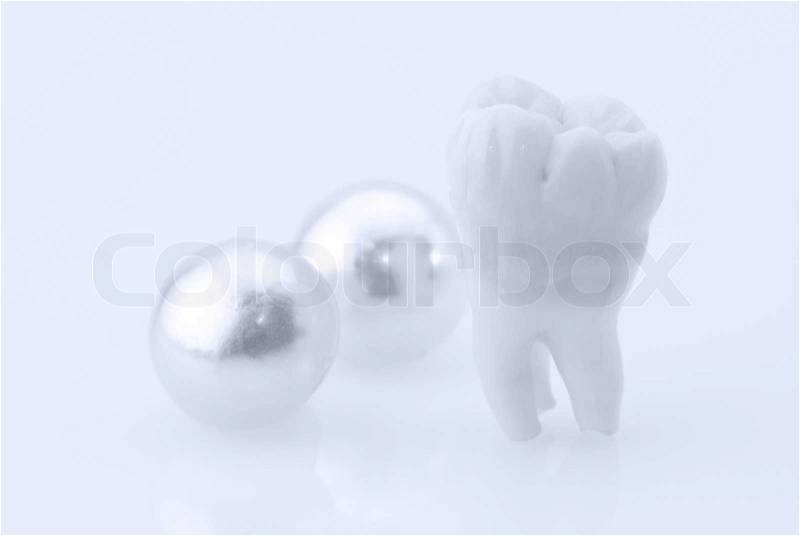 Healthy teeth concept. Real human wisdom tooth and natural pearls, stock photo